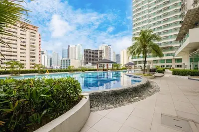 a large swimming pool in a city with tall buildings at Yūgen 幽玄 Makati Home - Malls, Little Tokyo, Pool in Manila