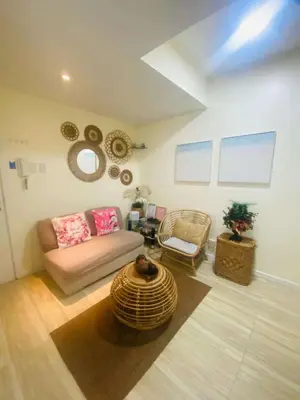 a living room with a couch and a chair at Sole Sisters Staycation in Manila