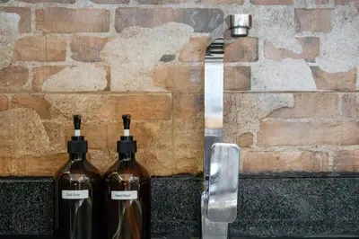two bottles of wine sitting next to a brick wall at Best Condo in Makati Near Airport and FREE Parking! in Manila