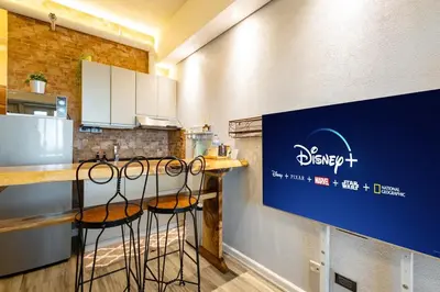 a kitchen with a counter with stools at a bar at Best Condo in Makati Near Airport and FREE Parking! in Manila