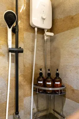 a soap dispenser and bottles on a shelf in a bathroom at Best Condo in Makati Near Airport and FREE Parking! in Manila
