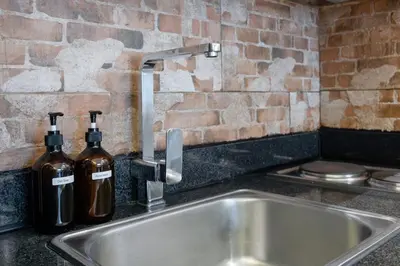 a kitchen sink with two bottles of wine at Best Condo in Makati Near Airport and FREE Parking! in Manila