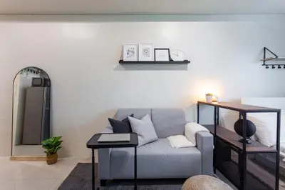 a living room with a couch and a table at Makati Condo Near NAIA & Greenbelt - Free Parking! in Manila
