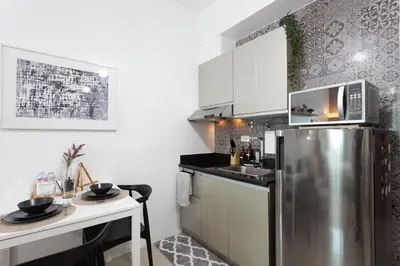 a kitchen with a stainless steel refrigerator and a sink at Makati Condo Near Airport & Greenbelt in Manila
