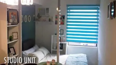 a room with a window with a couch and a table at Portovita Towers in Manila