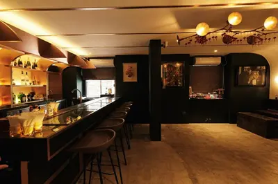 a bar in a restaurant with bar stools at The Kin House - Poblacion Botique Hotel in Manila