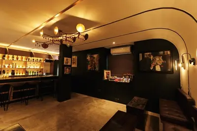 a room with a bar with a table and a counter at The Kin House - Poblacion Botique Hotel in Manila