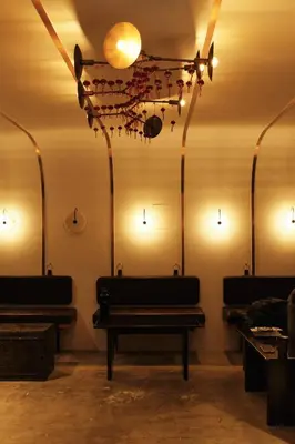 a room with benches and lights on the wall at The Kin House - Stay in Art Poblacion in Manila