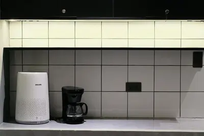 a coffee maker sitting on a counter in a kitchen at The Kin House - Hotel in the Heart of Poblacion in Manila