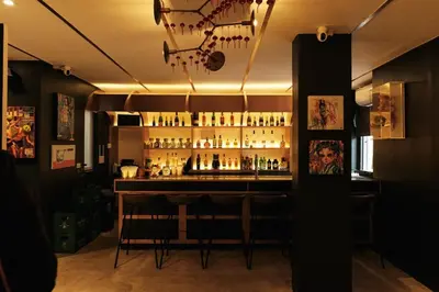 a bar in a room with a bunch of bottles at The Kin House - Hotel in the Heart of Poblacion in Manila