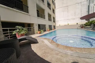 a swimming pool in the middle of a building at Relax & WFH in Vibrant & Cozy Greenbelt Condo with Pool in Manila