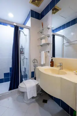 a bathroom with a sink and a toilet and a shower at Relax & WFH in Vibrant & Cozy Greenbelt Condo with Pool in Manila