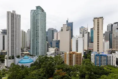 a view of a city with tall buildings at Relax & WFH in Vibrant & Cozy Greenbelt Condo with Pool in Manila