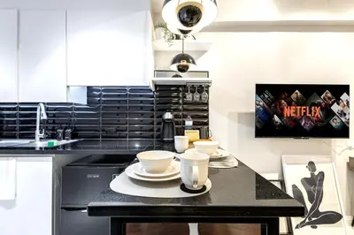 a kitchen with a table with two cups on it at NEW! Beautiful Studio in Greenbelt Makati in Manila