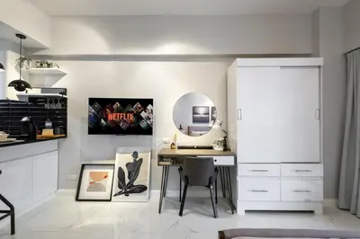 a white room with a desk and a mirror at NEW! Beautiful Studio in Greenbelt Makati in Manila