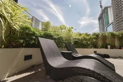 two chairs sitting next to each other on a patio at NEW! Beautiful Studio in Greenbelt Makati in Manila