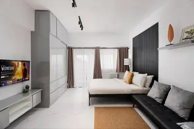a living room with a couch and a tv at NEW! Modern Condo in Greenbelt Makati with Pool & Gym in Manila