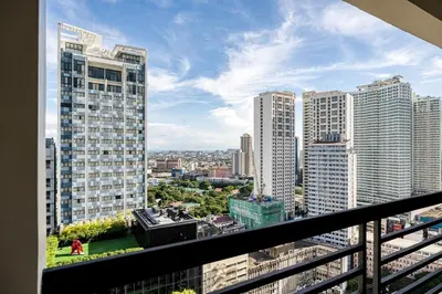 a view of a city from the balcony of a building at NEW! Modern Condo in Greenbelt Makati with Pool & Gym in Manila