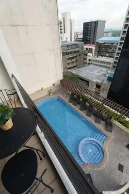 a swimming pool on the roof of a building at Studio in Greenbelt Makati with Fiber WiFi & Free Pool Access in Manila