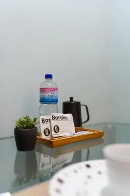 a bottle of water sitting on a tray with a bag of bar snacks at Studio in Greenbelt Makati with Fiber WiFi & Free Pool Access in Manila