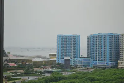 a view of a city with tall buildings and the ocean at Gentry Manor Pet Friendly Near MOA&NAIA Okada Complex 8T in Manila