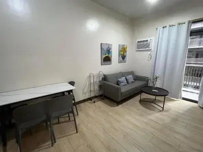 a living room with a couch and a table at Gentry Manor Pet Friendly Near MOA&NAIA Okada Complex 8T in Manila