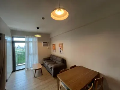 a living room with a couch and a table at Gentry Manor Manila Bay Okada Complex MOA&Airport WiFi Netflix 8K in Manila