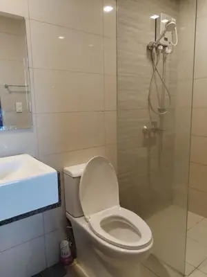 a bathroom with a shower and a toilet and a sink at Gentry Manor Manila Bay Okada Complex MOA&Airport WiFi Netflix 8K in Manila