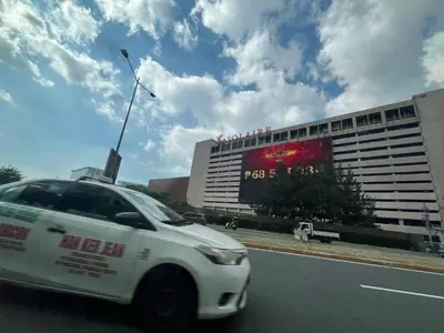 a white car driving down a street in front of a building at Gentry Manor Manila Bay Okada Complex MOA&Airport WiFi Netflix 8K in Manila