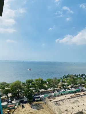 a view of a beach with a boat in the water at Baywatch tower 1604 in Manila