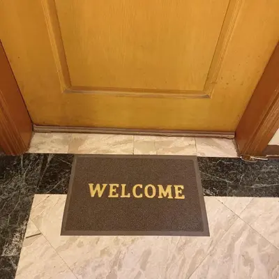 a welcome mat on the floor in front of a door at Baywatch tower 1604 in Manila