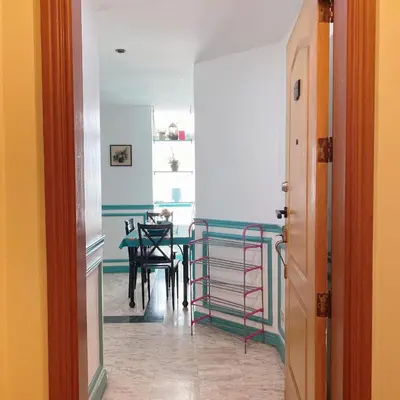 a hallway with a table and a dining room at Baywatch tower 1604 in Manila