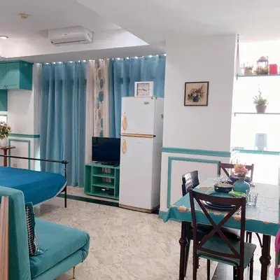 a kitchen with a refrigerator and a table and chairs at Baywatch tower 1604 in Manila