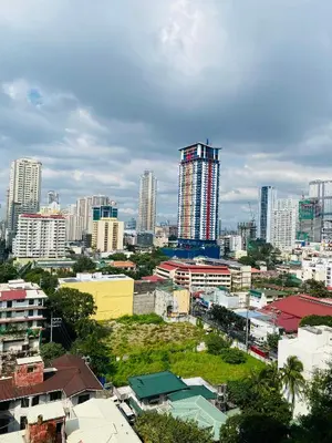 a city skyline with tall buildings in the background at Baywatch tower 1604 in Manila
