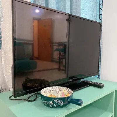 a bowl of food sitting on a table in front of a television at Baywatch tower 1604 in Manila