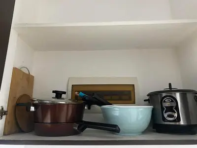 a kitchen counter with pots and a toaster and a bowl at Ohana Buenbyahe Studio Rooms with balcony in Mandaluyong, Edsa Shaw Mrt and Megamall in Manila