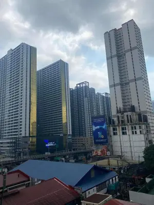 a group of tall buildings in a city at Ohana Buenbyahe Studio Rooms with balcony in Mandaluyong, Edsa Shaw Mrt and Megamall in Manila