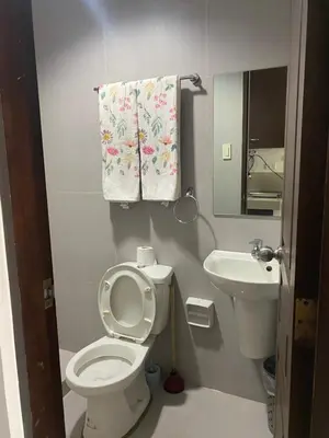 a small bathroom with a toilet and a sink at Ohana Buenbyahe Studio Rooms with balcony in Mandaluyong, Edsa Shaw Mrt and Megamall in Manila