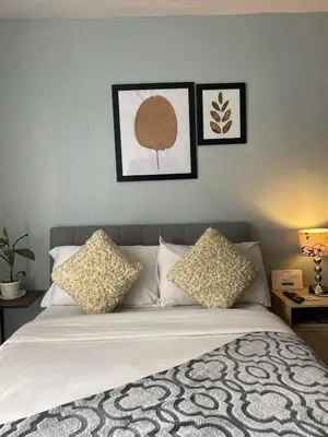 a bedroom with a bed with three pictures on the wall at Nature Inspired Affordable Rooms in F RESIDENCE near Edsa Shaw Pasig Megamall Shangrila and MRT in Manila