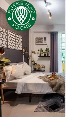 a bedroom with a bed with a green sign on it at Nature Inspired Affordable Rooms in F RESIDENCE near Edsa Shaw Pasig Megamall Shangrila and MRT in Manila