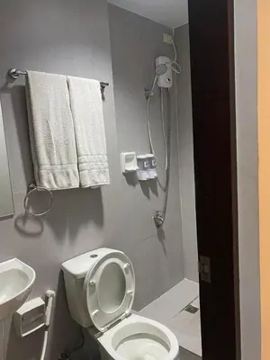 a bathroom with a white toilet and a sink at Nature Inspired Affordable Rooms in F RESIDENCE near Edsa Shaw Pasig Megamall Shangrila and MRT in Manila