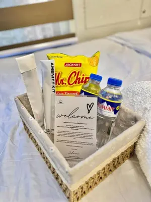 a tray with a bag of chips and bottles of water at Sunshine 100 Cozy Mandaluyong Studio Near BGC in Manila