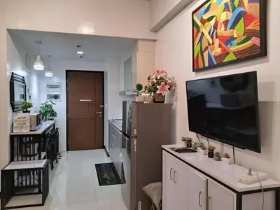 a living room with a flat screen tv on a wall at 101 Newport Boulevard-Hyuna Place, Across NAIA T3 in Manila