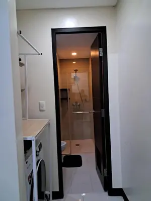 a bathroom with a shower with a glass door at 101 Newport Boulevard-Hyuna Place, Across NAIA T3 in Manila
