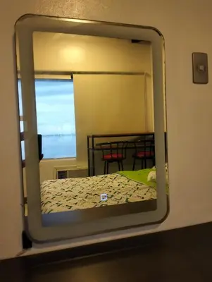 a mirror reflection of a bed in a room at Chic Haven in Manila