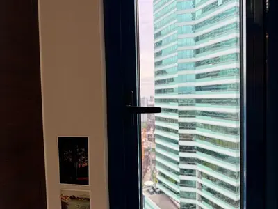 a view of a tall building from a window at Executive Suite Air Residence Style Comfort Makati 300 Mbps in Manila