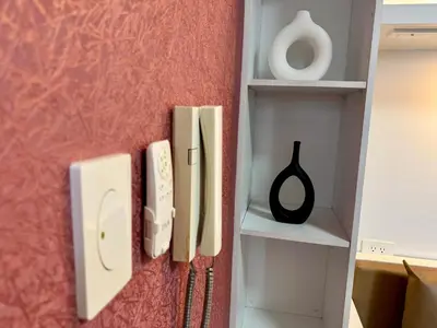 a wall with two light switches and a shelf at Executive Suite Air Residence Style Comfort Makati 300 Mbps in Manila