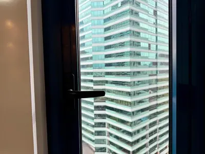 a view of a tall building from a window at Executive Suite Air Residence Style Comfort Makati 300 Mbps in Manila