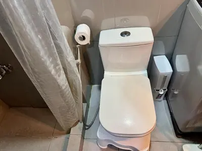 a bathroom with a toilet and a roll of toilet paper at Executive Suite Air Residence Style Comfort Makati 300 Mbps in Manila