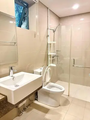 a bathroom with a toilet and a sink and a shower at Across NAIA terminal 3 in Manila